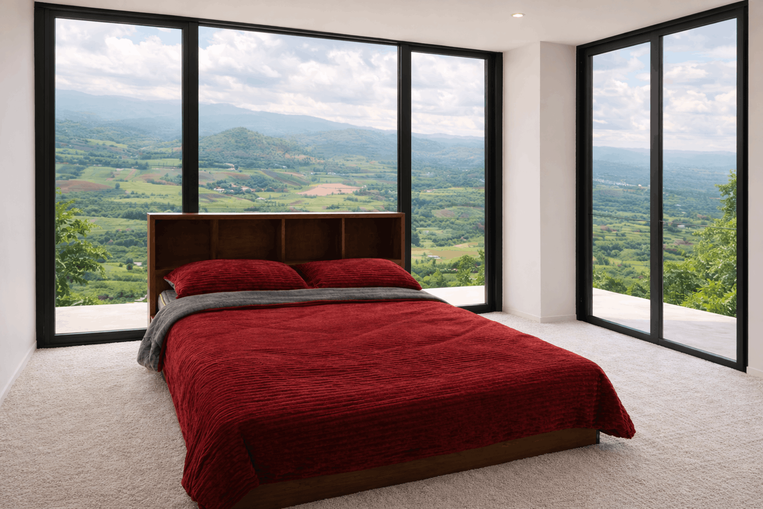 The Ridge Suite — bed framed by floor-to-ceiling windows over the valley